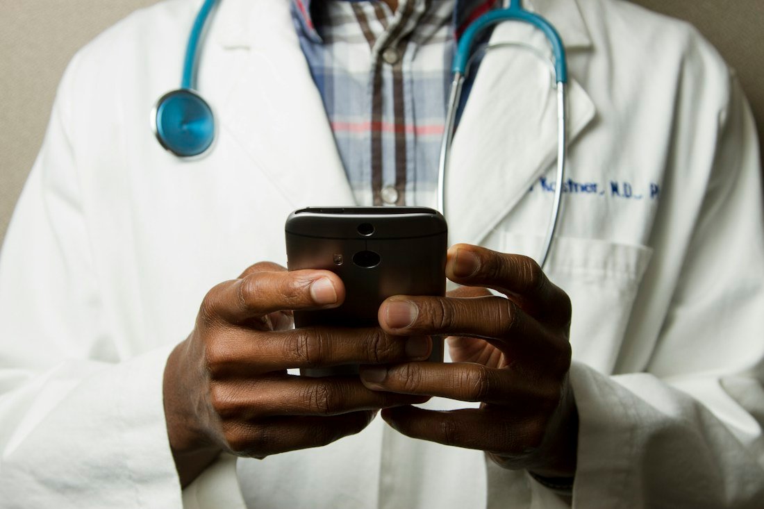 Doctor using a digital device in a clinical setting